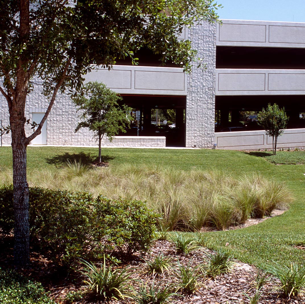 COM_S-0187 Lanndscaped lawn in front of a parking garage